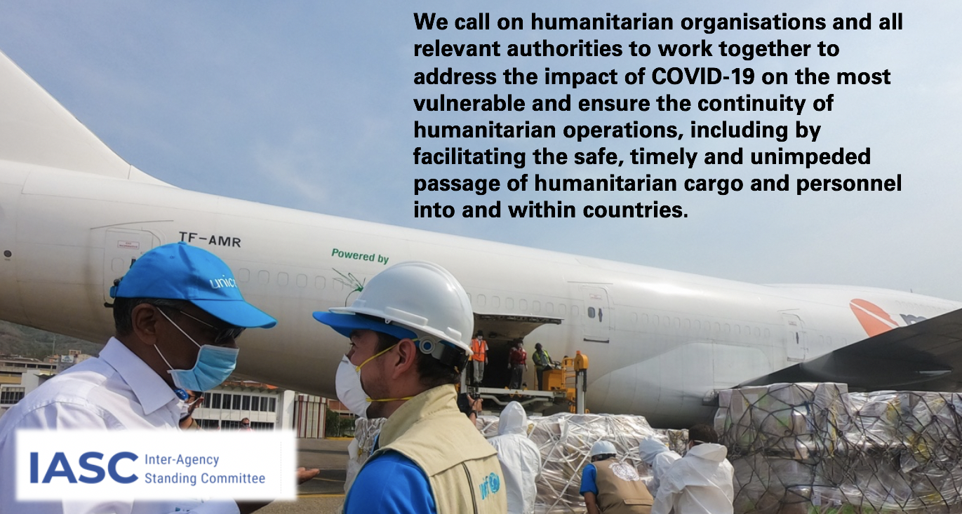 Image of two health/aid workers delivering cargo shipments for those in need