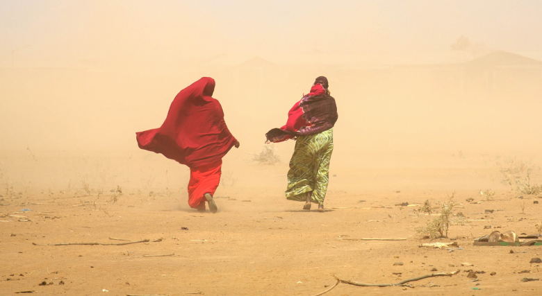 Two women walking in a drought-affected area of Ethiopia.