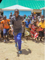 Photo of a group of smiling children running 